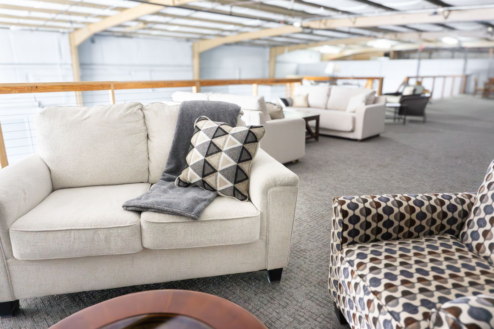 White couches and a pouf in the Loft