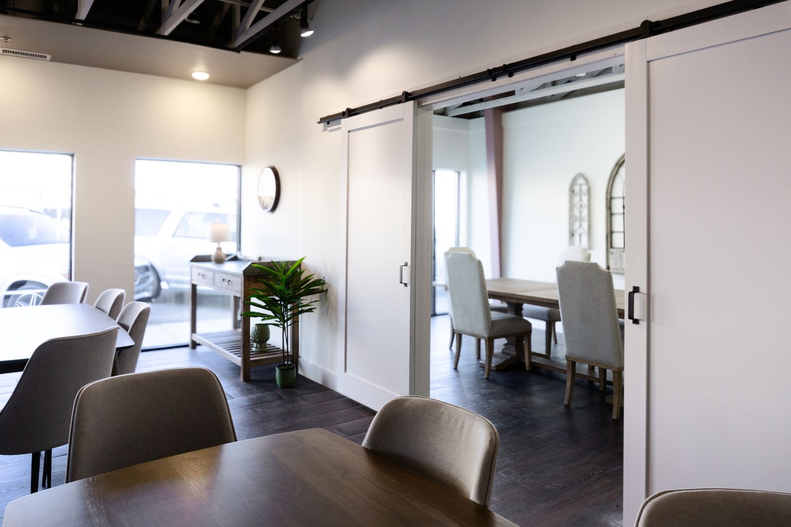 Wide view of the signing office connecting through open barn doors to the venue beyond