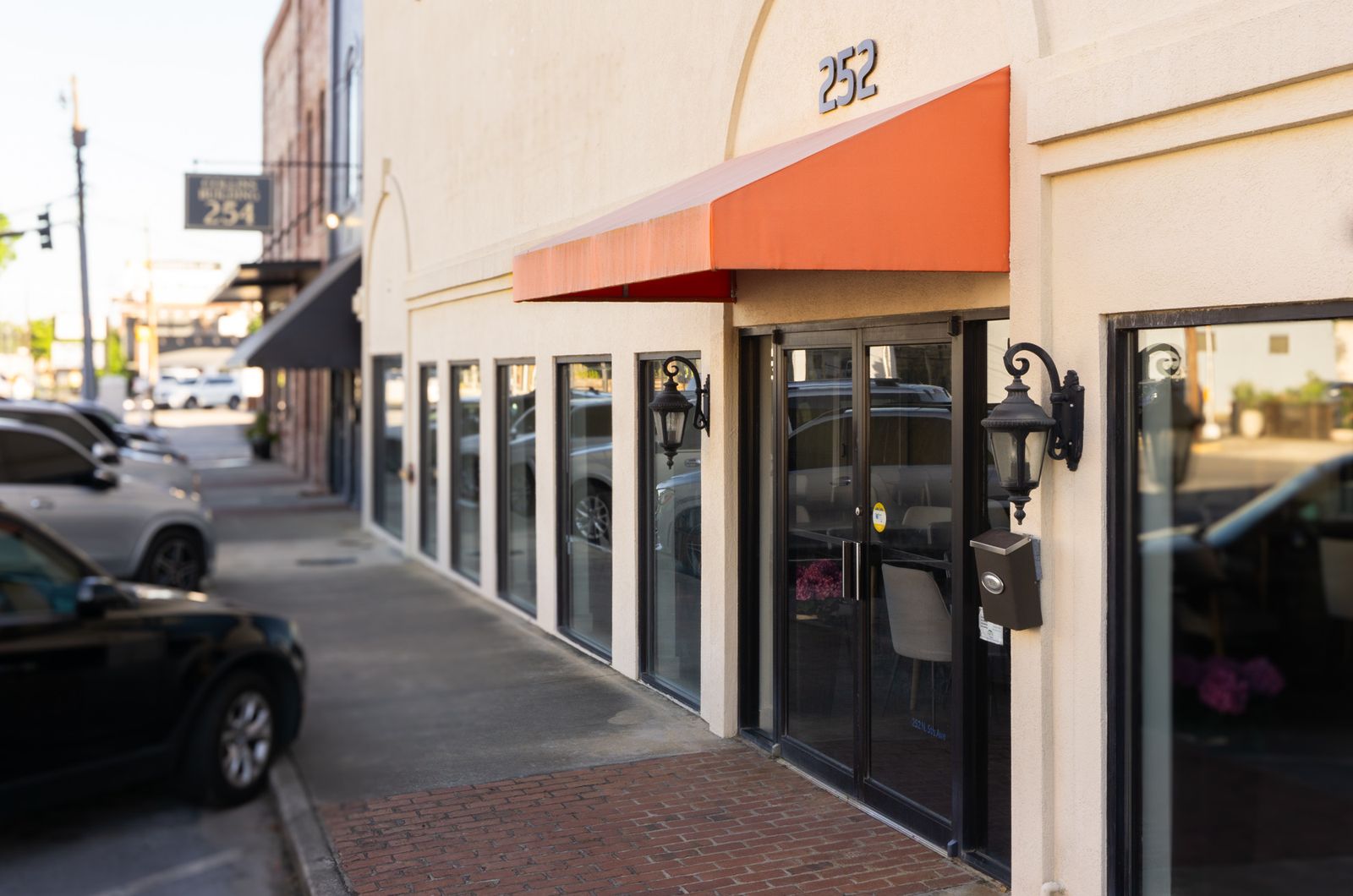 River Arts Venue storefront with cream facade and orange awning on a downtown street